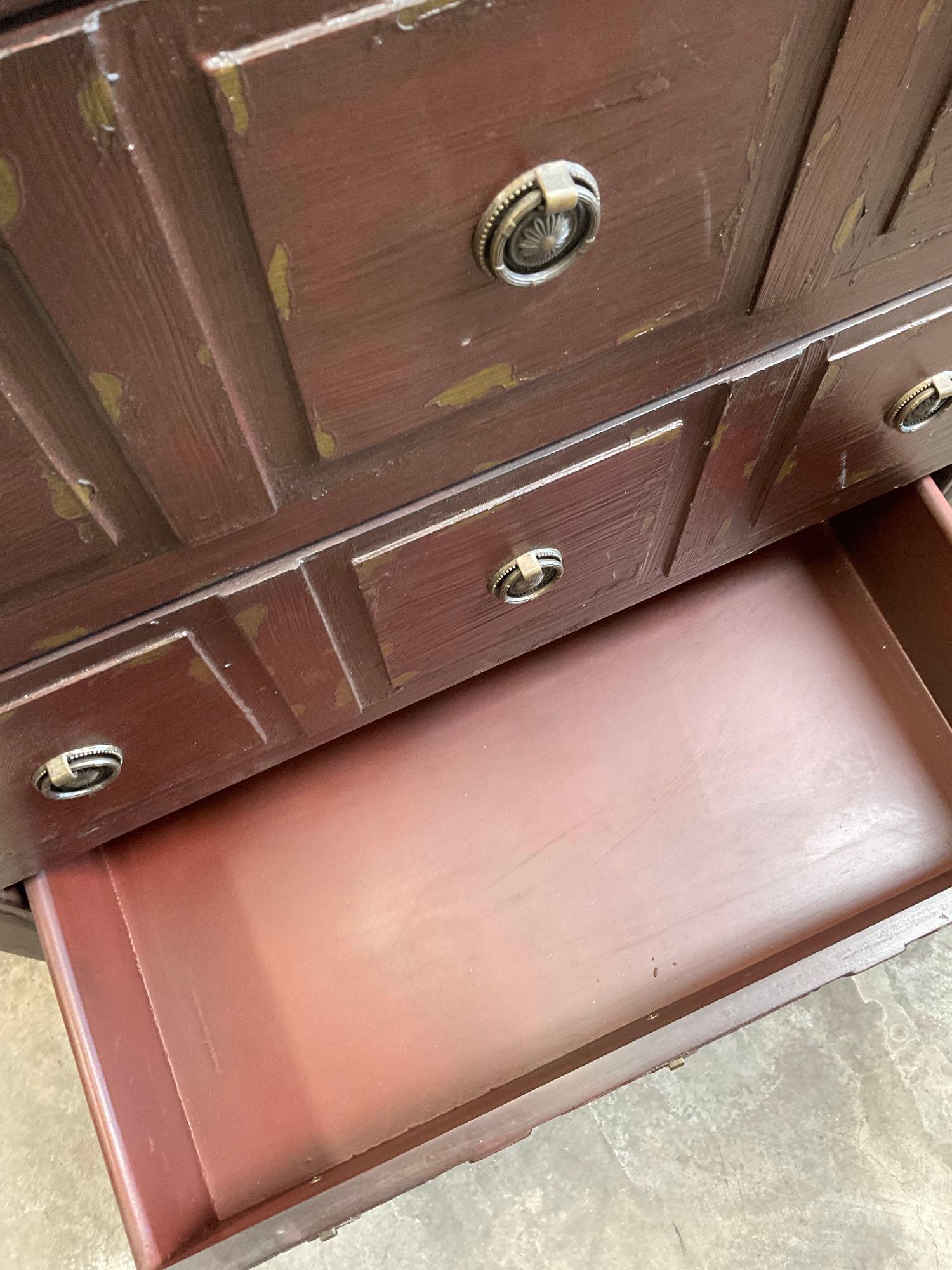 Three drawer wood dresser with metal accents. 32" x 27" x 14"