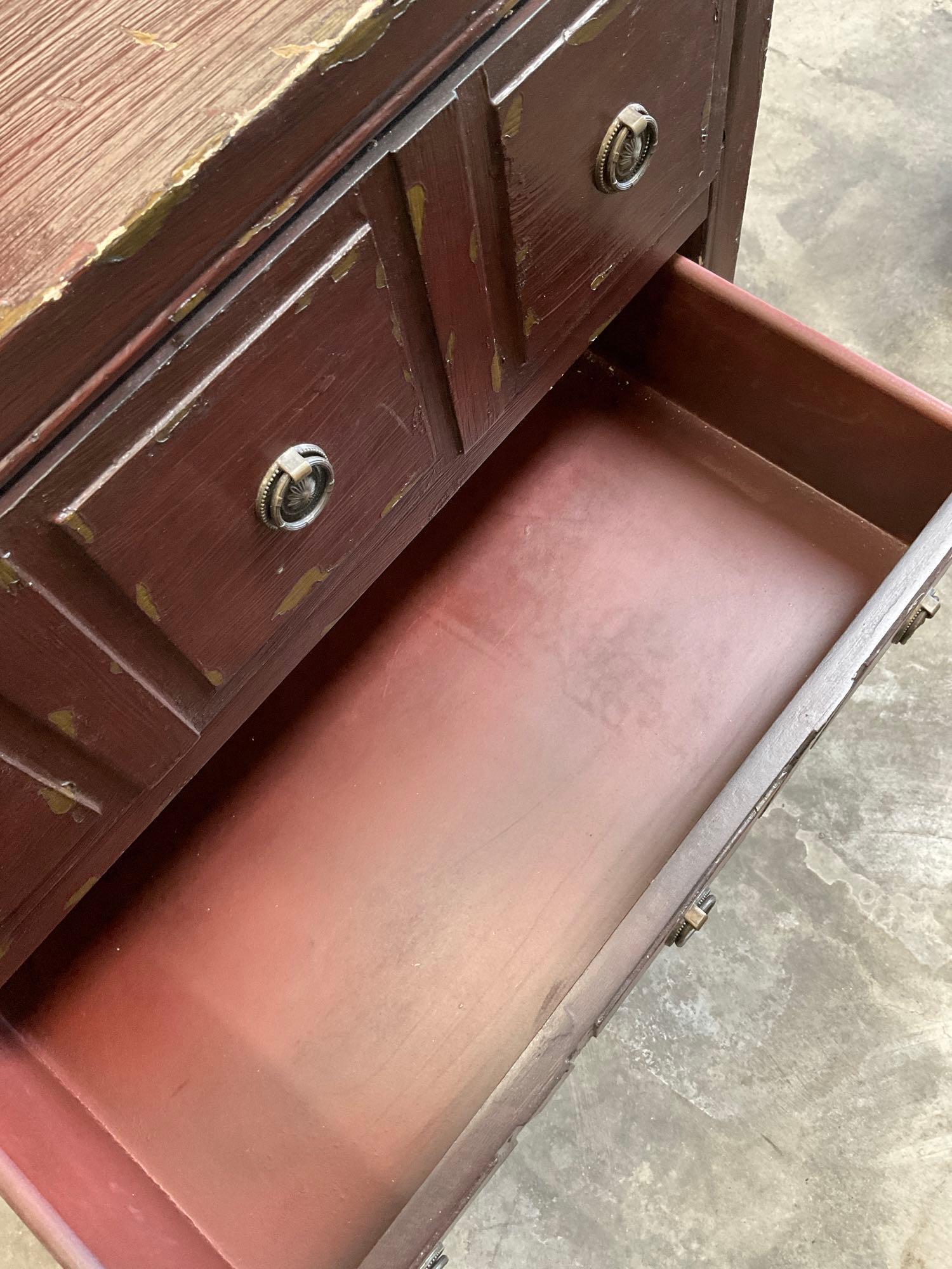 Three drawer wood dresser with metal accents. 32" x 27" x 14"