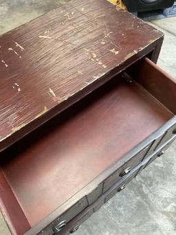 Three drawer wood dresser with metal accents. 32" x 27" x 14"