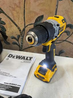 Dewalt bag, DCD706 drill driver, charger station and two batteries. Turned on WORKS