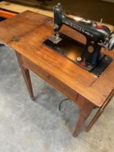 Vintage electric Singer sewing machine with knee peddle, turns on with cabinet