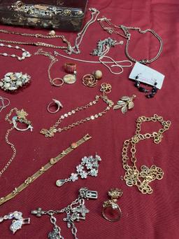 Plastic storage and assorted custom jewelry. Over 50 pieces