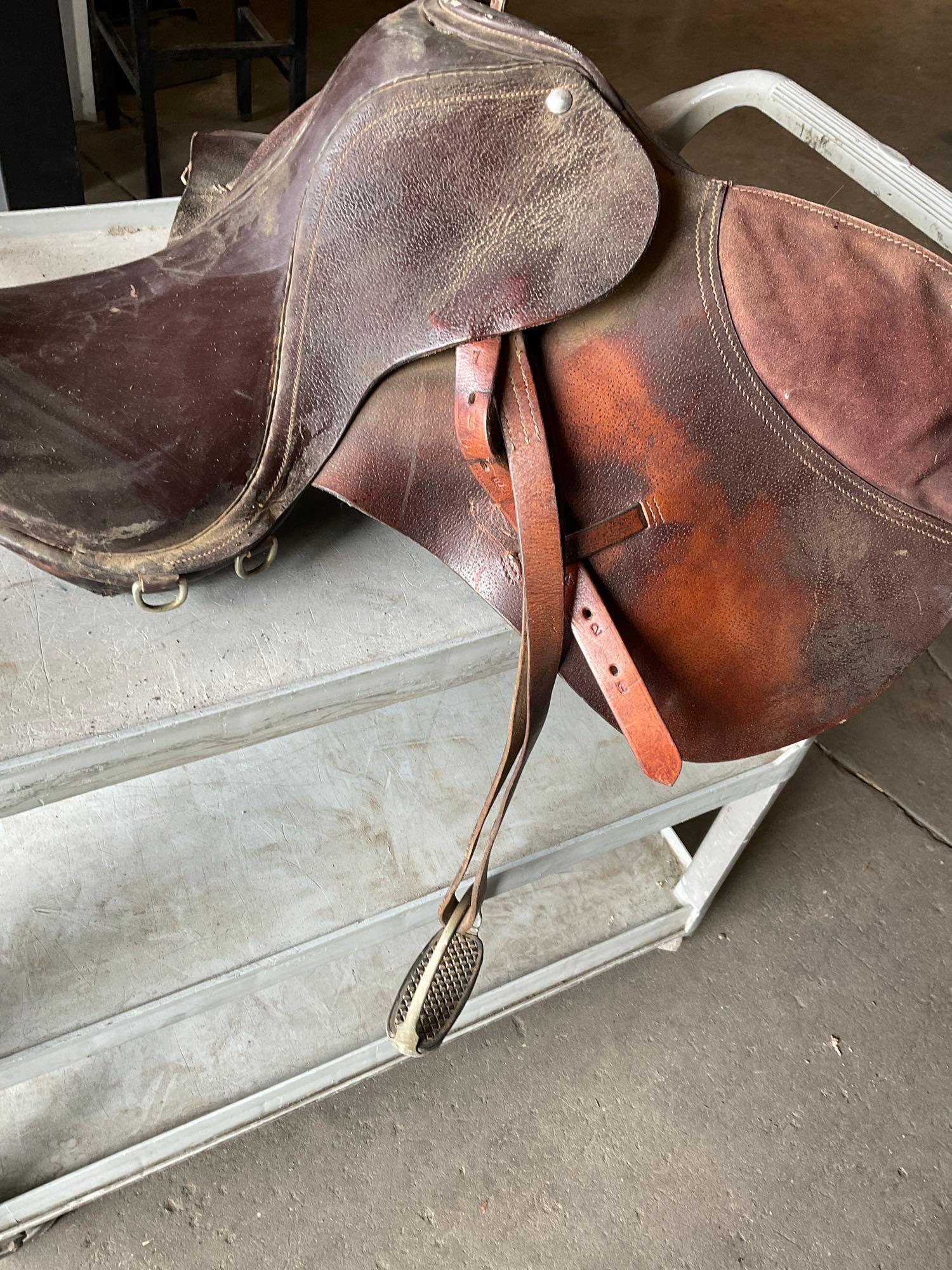 Large lot of horse items. Saddle, Tux head ropes feed bag, halters, leashes, girth, stirrup, etc.