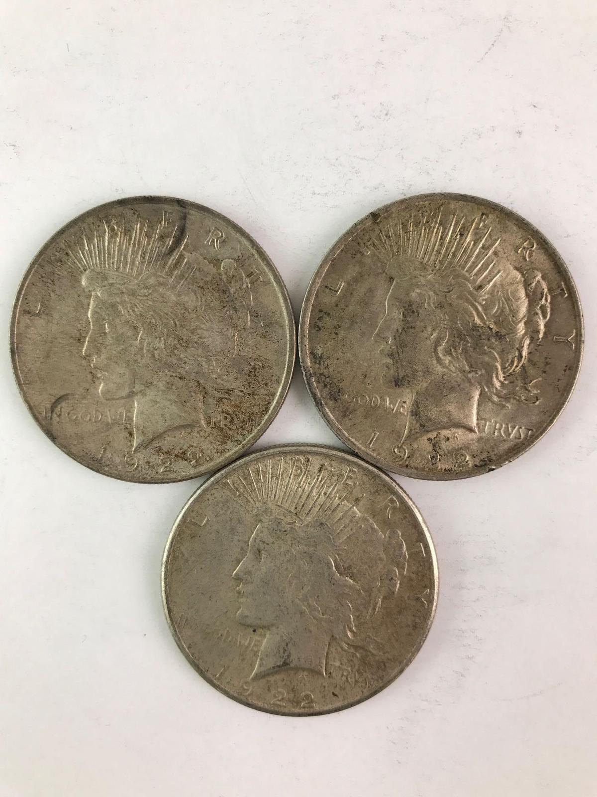 Group of three 1922 peace silver dollars