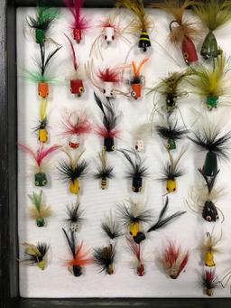 Case with 66 fly fishing popper lures