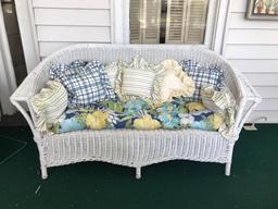 Antique wicker couch with pillows