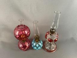 Group of three miniature glass oil lamps