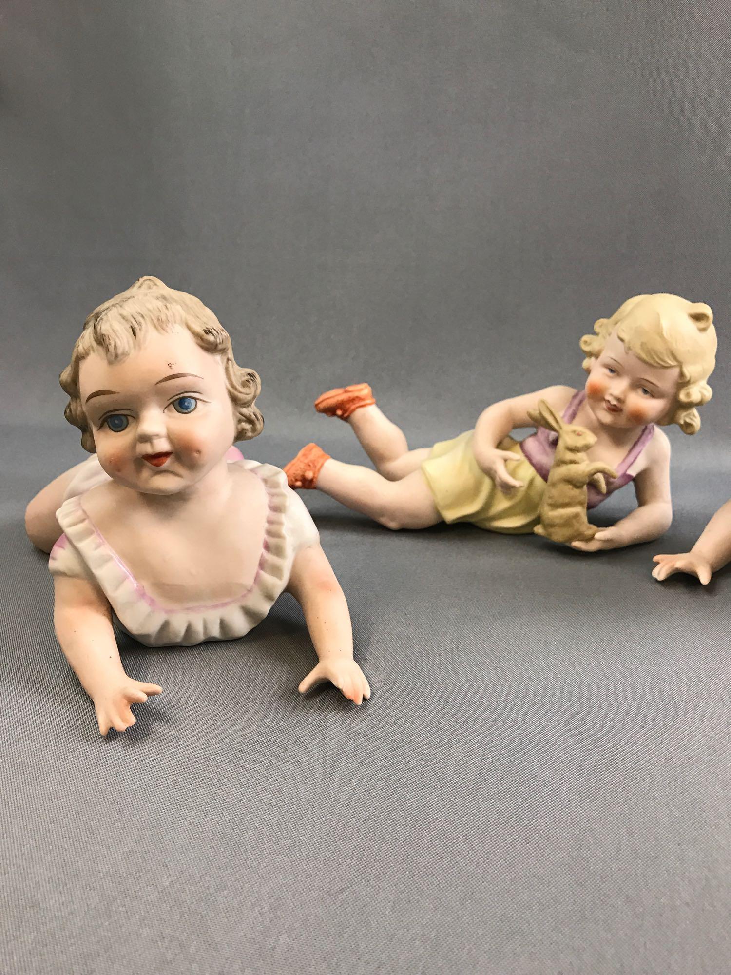 Group of vintage porcelain china piano babies.