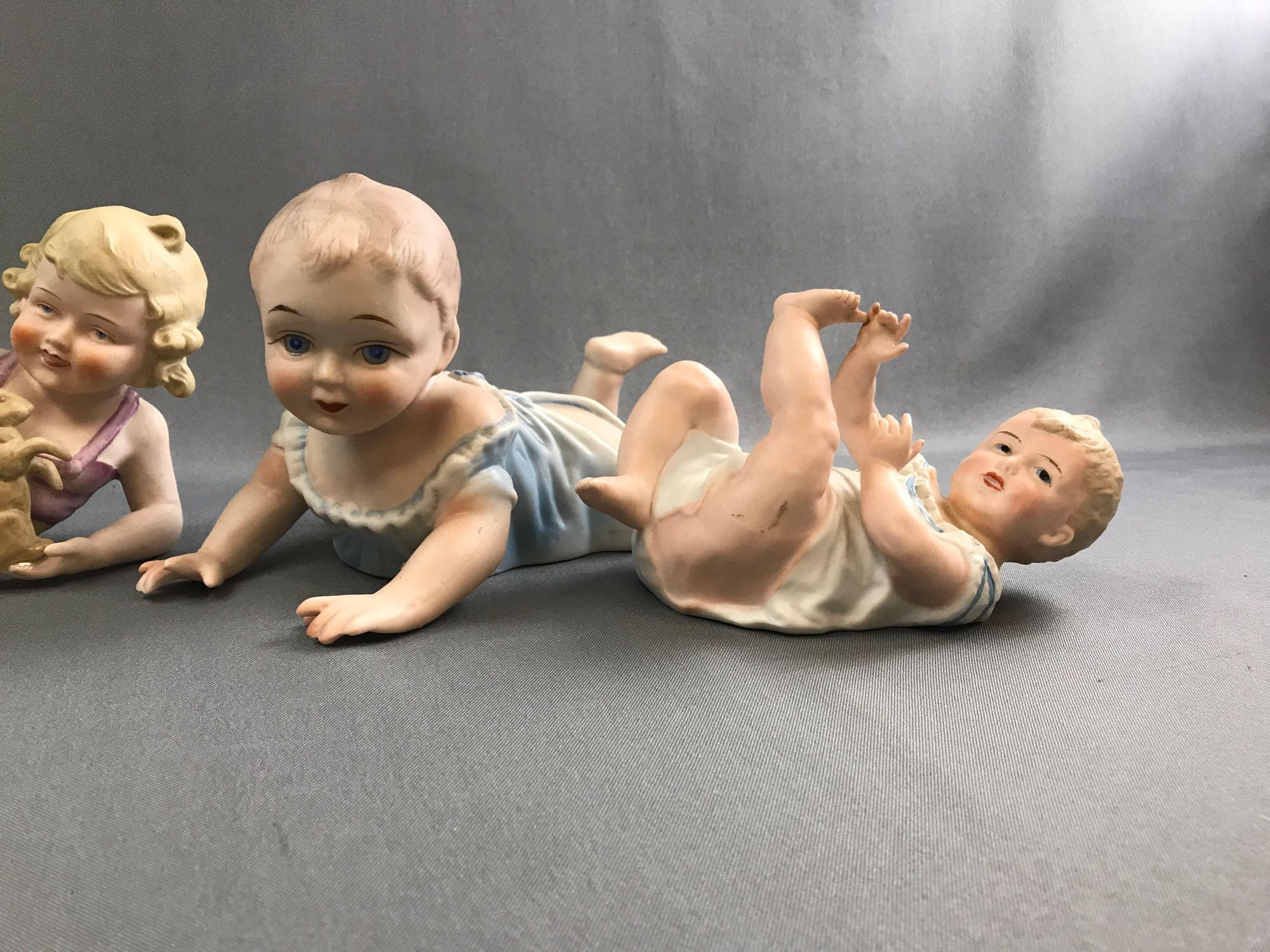 Group of vintage porcelain china piano babies.