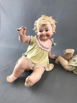 Group of vintage antique piano babies and doll