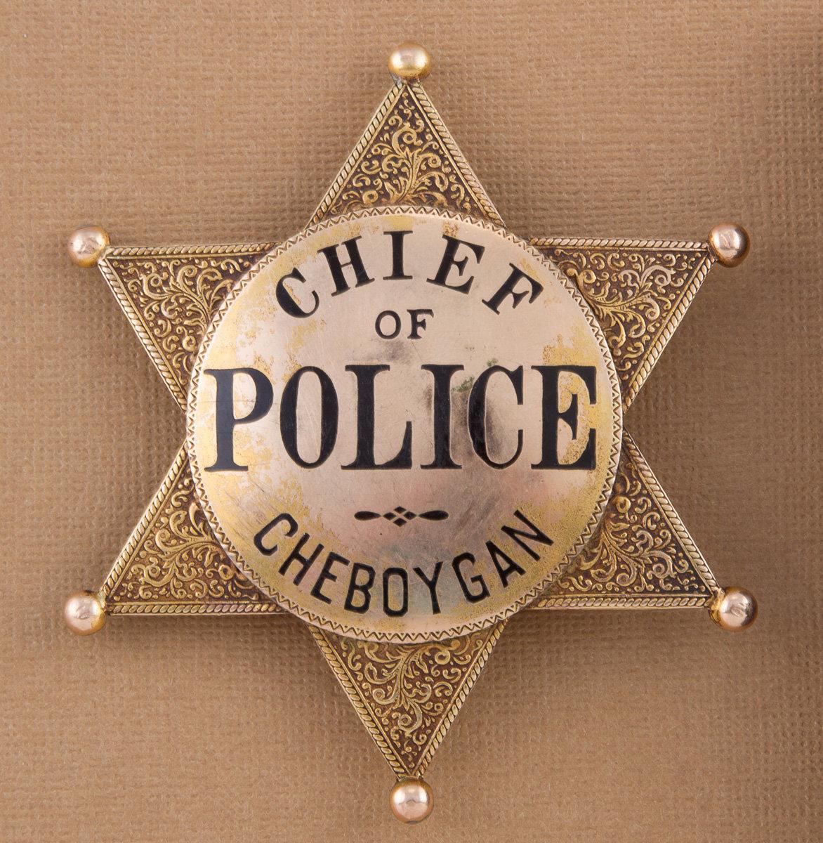 Heavy gold plated, very ornate 6 point ball star Badge for "CHIEF OF POLICE, CHEBOYGAN".  Hallmark "