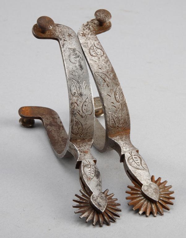 Pair of "Star" marked Buermann single engraved Spurs with unique shanks and leaf pattern.