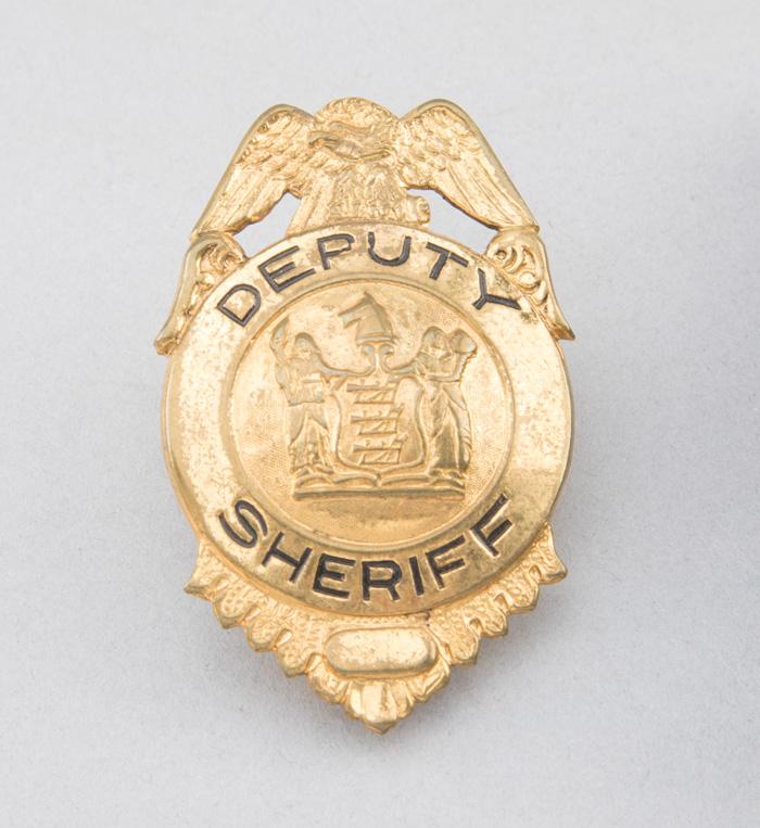 Deputy Sheriff Badge, shield with eagle crest, 2 3/4" T, gold plate.  George Jackson Collection.