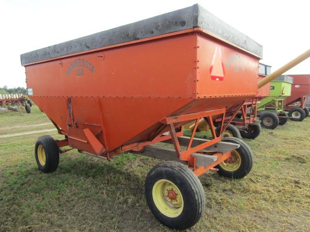 1650. MN 250 Gravity Box with Wood Extensions on MN 7 Ton Four Wheel Wagon,