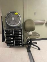 Misc. items including office chair, power strip, fan, and small office storage unit