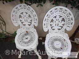 Two cast iron chairs