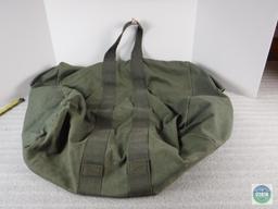 Olive drab colored canvas military duffle bag