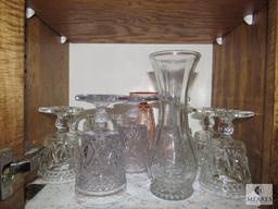 Contents of kitchen cabinet includes glass goblets base and plastic angel