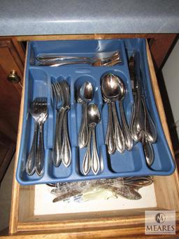 Contents of kitchen drawers include silverware utensils knives Plus