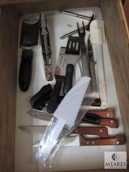 Contents of kitchen drawers include silverware utensils knives Plus