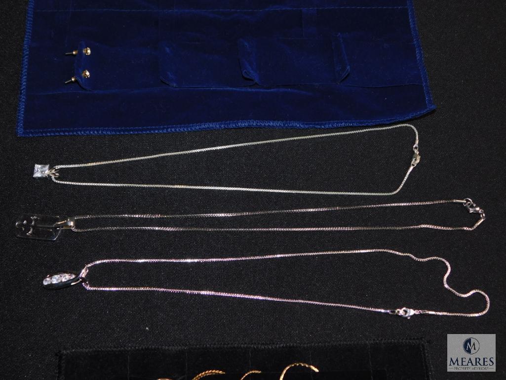 Assorted Gold-tone and silver-tone jewelry in "roll up" Organizer
