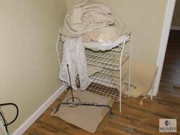 Wire Rack with assorted Rugs and Towels