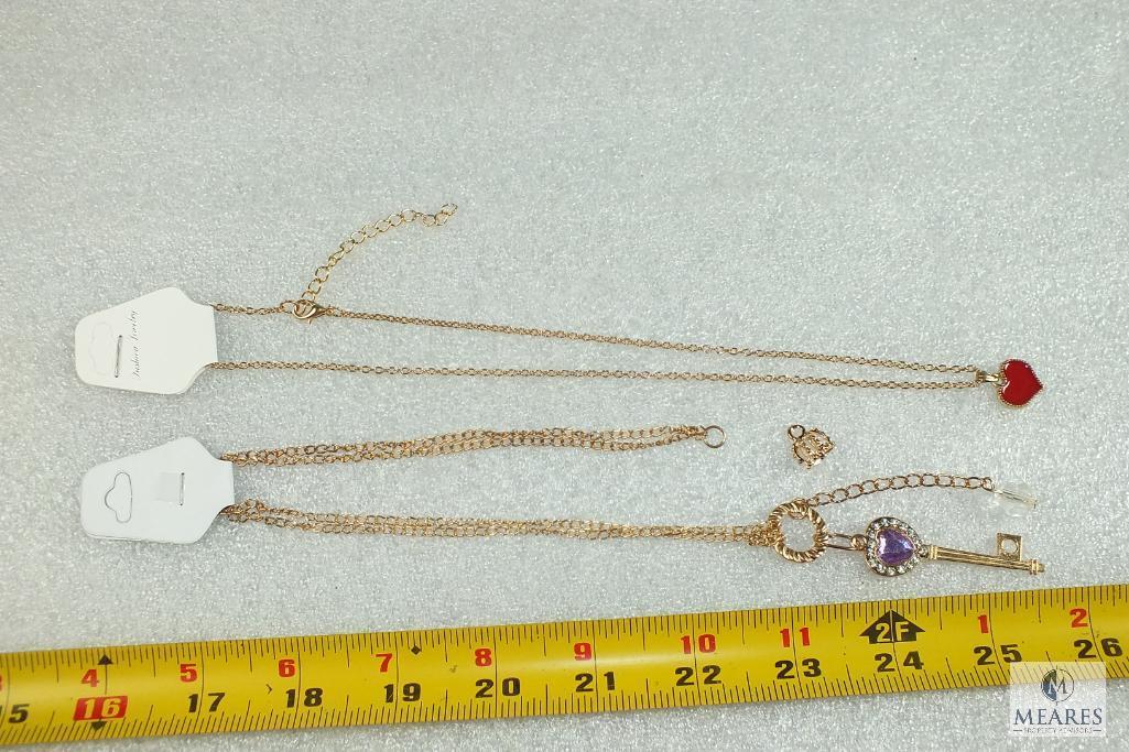 Lot of 2 Costume Jewelry Bracelets - gold tone with heart charm & skeleton key with rhinestones