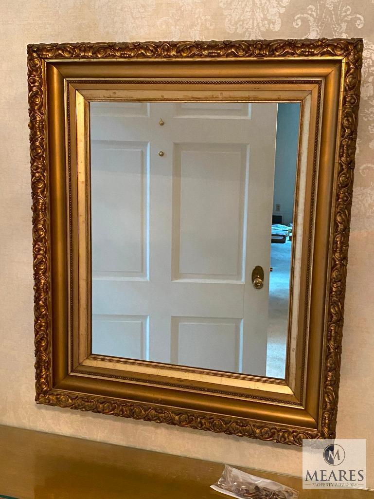 Mirror with gold-colored wooden frame