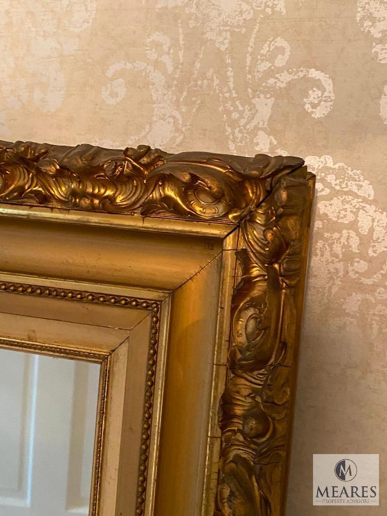 Mirror with gold-colored wooden frame