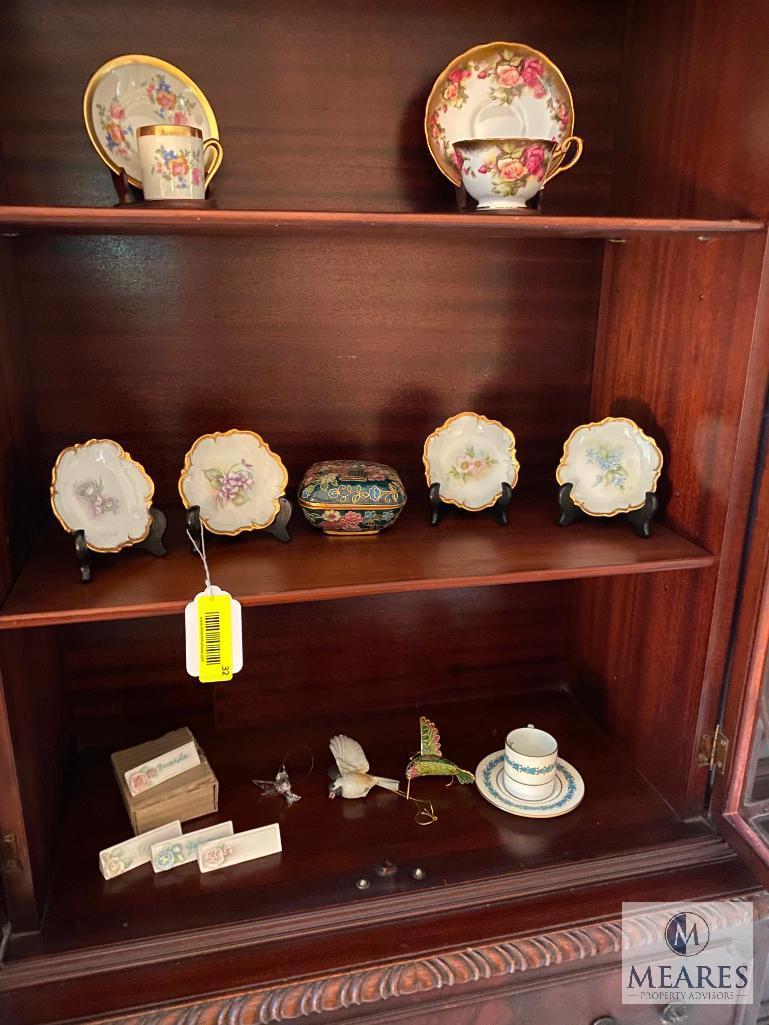 Contents of the china cabinet including porcelain vases, teacups, saucers, bowls