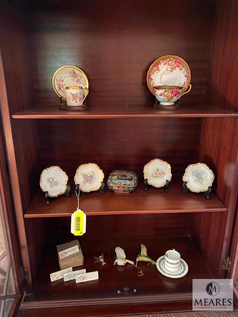 Contents of the china cabinet including porcelain vases, teacups, saucers, bowls