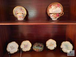 Contents of the china cabinet including porcelain vases, teacups, saucers, bowls