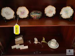 Contents of the china cabinet including porcelain vases, teacups, saucers, bowls