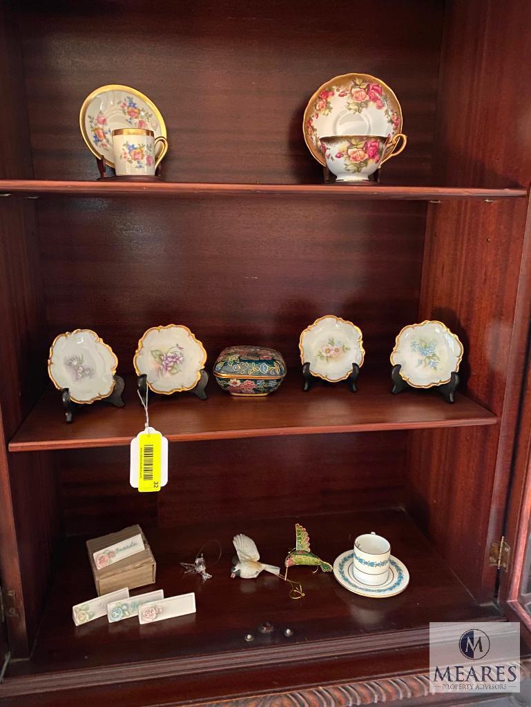 Contents of the china cabinet including porcelain vases, teacups, saucers, bowls