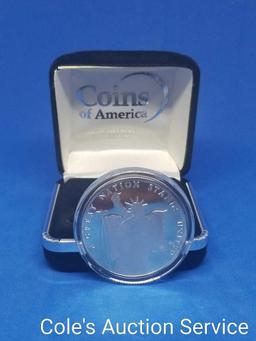 Coins of America Land of the Free one troy ounce fine silver coin. Beautiful mirror-like finish in