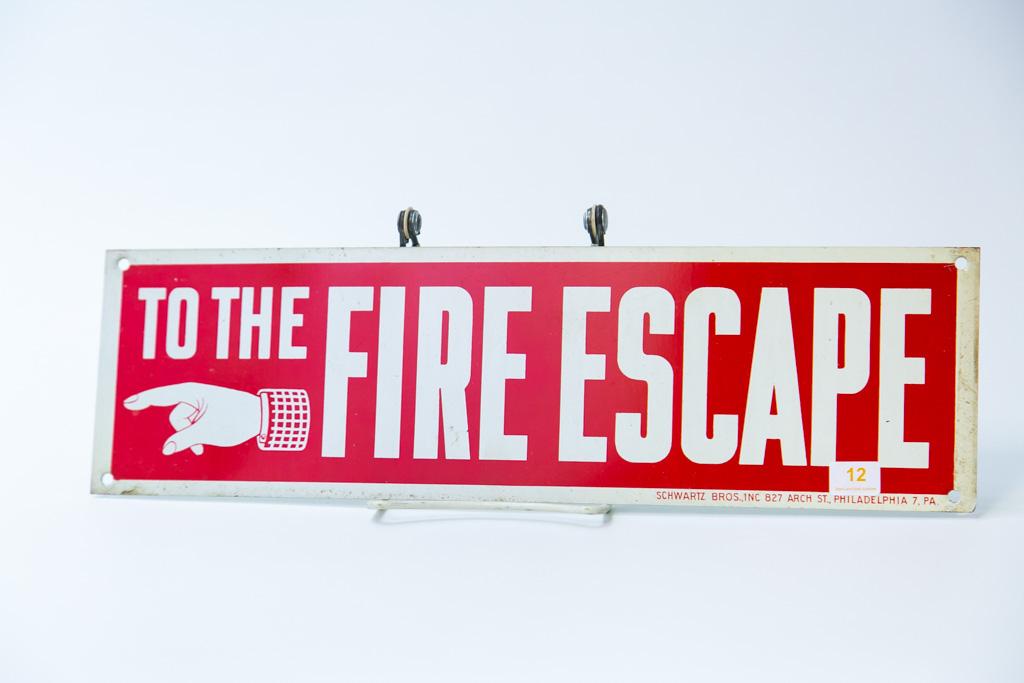 Metal "To The Fire Escape" sign