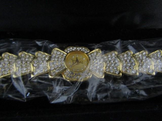 N I B Ladies Quartz Watch In Gold Tone And Filled W/ Rhinestones