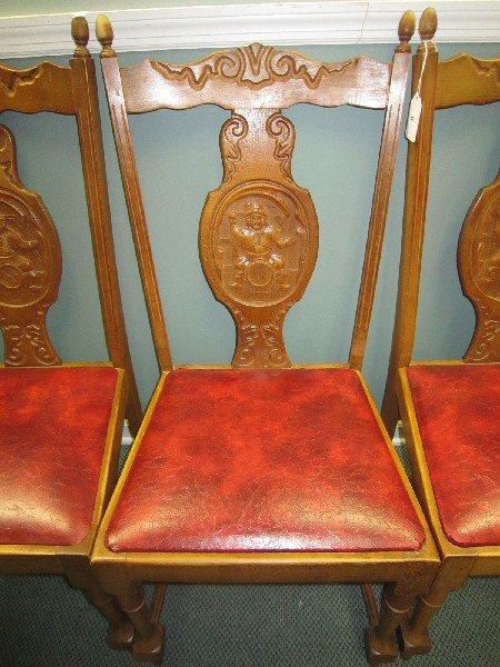 6 Wood Chairs w/ Ornate Carved Motif w/ Man on Barrel Carved Medallion & Red Leather Seats