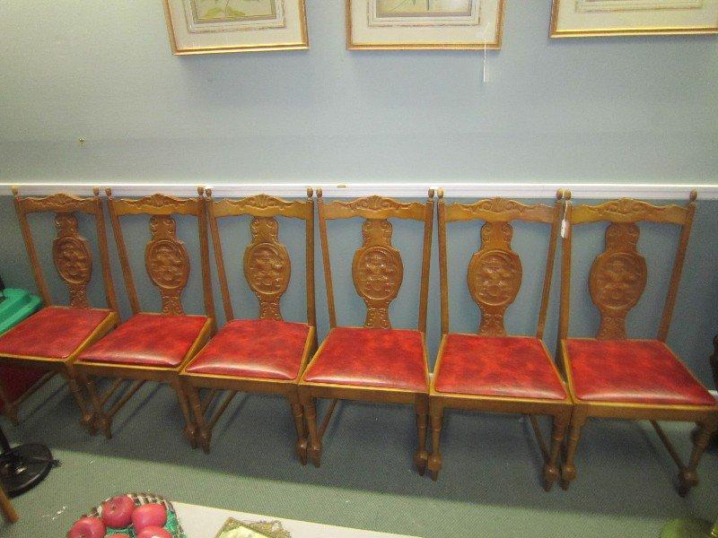 6 Wood Chairs w/ Ornate Carved Motif w/ Man on Barrel Carved Medallion & Red Leather Seats