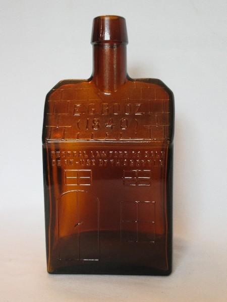 E.G. Booz Amber Pressed Glass Old Cabin Design Bottle