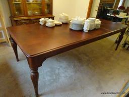 (DR) LIKE NEW HUGE FAMILY GATHERING DINING ROOM TABLE. HAS WALNUT WOOD TONE FINISH AND 2 BOARDS.