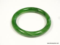 SOLID HAND CARVED AND POLISHED JADE BRACELET. 62.3 GRAMS.