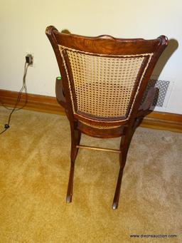 (LR) ANTIQUE VICTORIAN WALNUT CANE SEAT & BACK ROCKING CHAIR WITH ARMS. MEASURES 22.5"X30"X37". IN