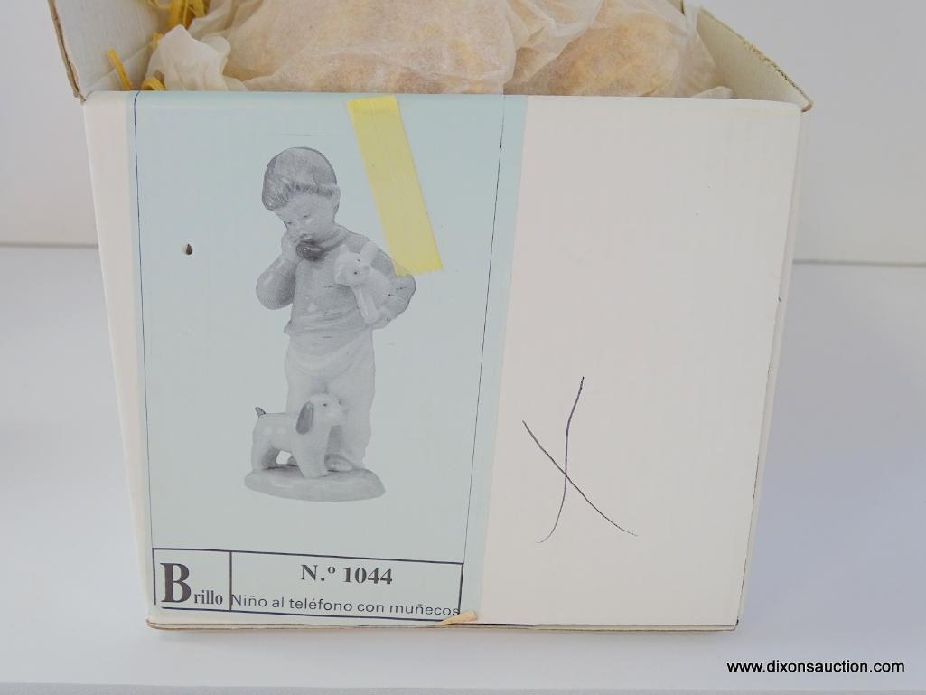 NAO BY LLADRO NINO AL TELEFONO CON MUNECOS. ITEM# 1044. 7" TALL. IN THE ORIGINAL BOX.