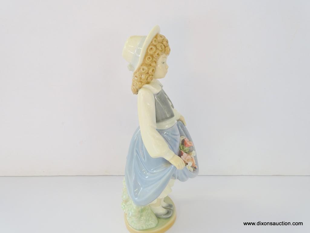 NAO BY LLADRO COLEGIALA CON FLORES. ITEM# 1.005. 8" TALL. IN THE ORIGINAL BOX.