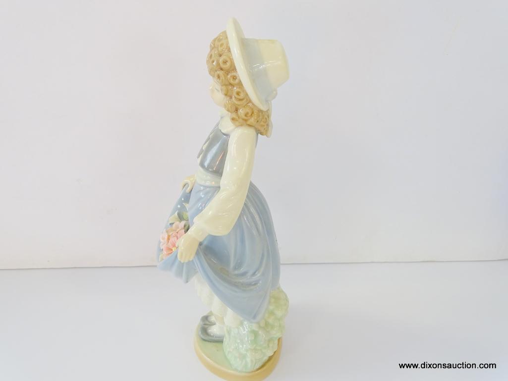 NAO BY LLADRO COLEGIALA CON FLORES. ITEM# 1.005. 8" TALL. IN THE ORIGINAL BOX.