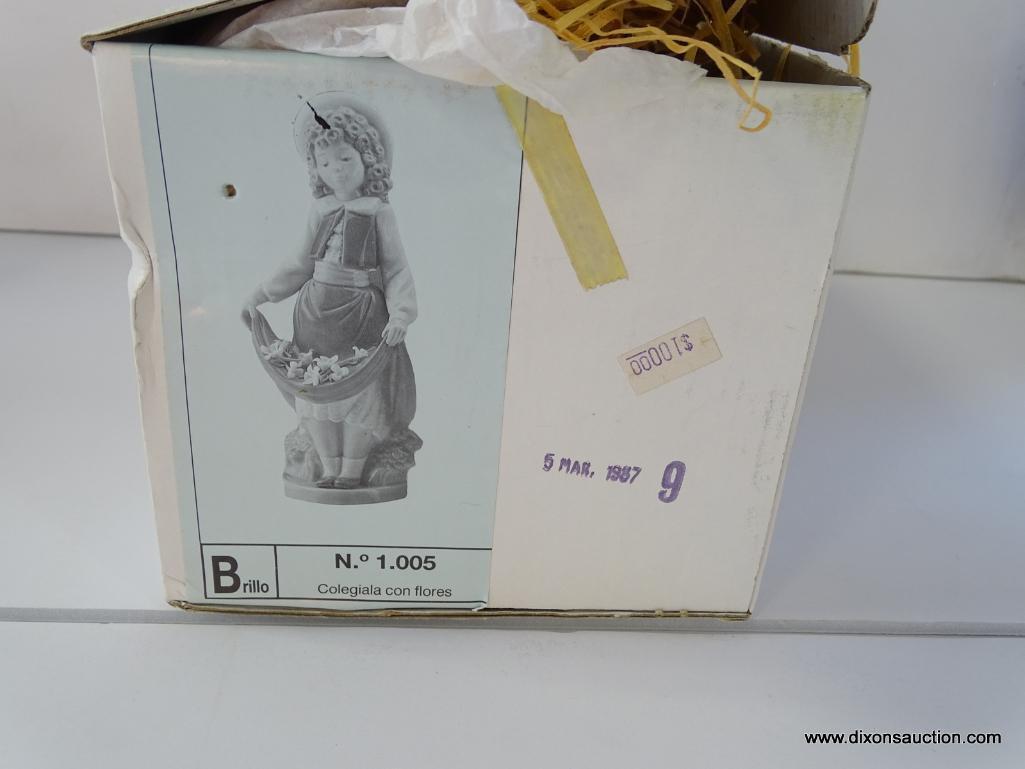 NAO BY LLADRO COLEGIALA CON FLORES. ITEM# 1.005. 8" TALL. IN THE ORIGINAL BOX.