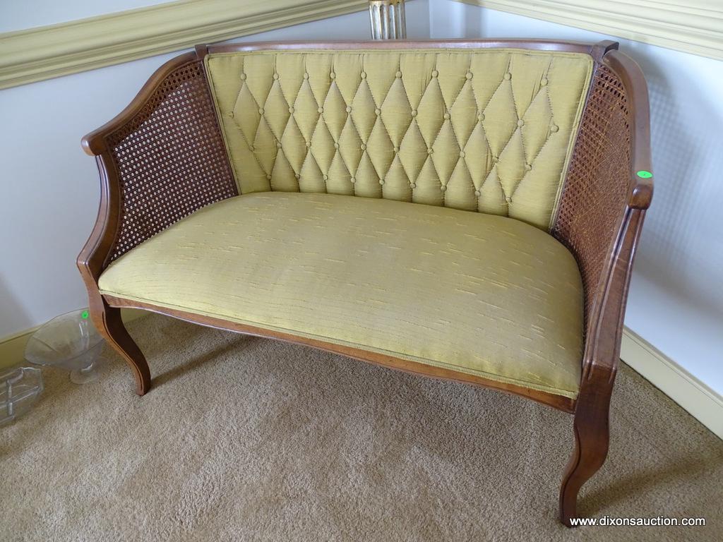 (DR) BOW LEGGED, UPHOLSTERED, AND CANE SIDED SETTEE: 44"x23"x28.5". IN EXCELLENT CONDITION AND READY