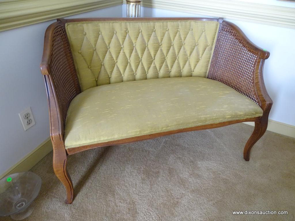 (DR) BOW LEGGED, UPHOLSTERED, AND CANE SIDED SETTEE: 44"x23"x28.5". IN EXCELLENT CONDITION AND READY