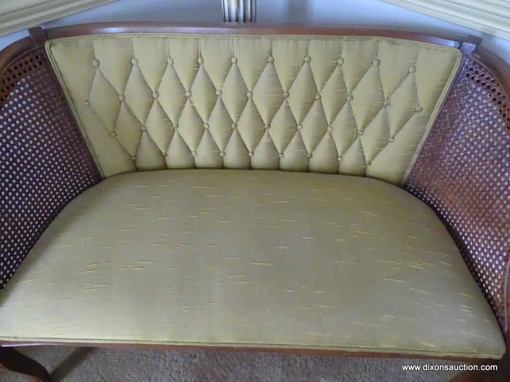 (DR) BOW LEGGED, UPHOLSTERED, AND CANE SIDED SETTEE: 44"x23"x28.5". IN EXCELLENT CONDITION AND READY